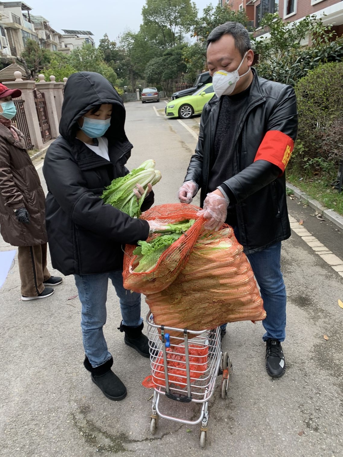 何晴同志（右二）在社区为居民分发蔬菜.jpg